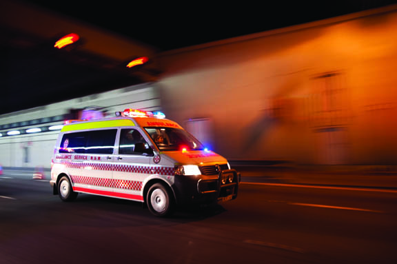 Paramedic ambulance crew responding to emergency